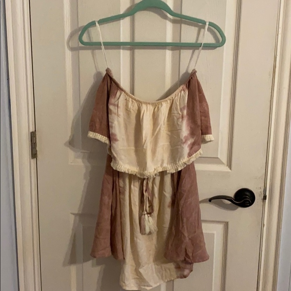 Sleeveless flowy tunic, fringe detail at bust.